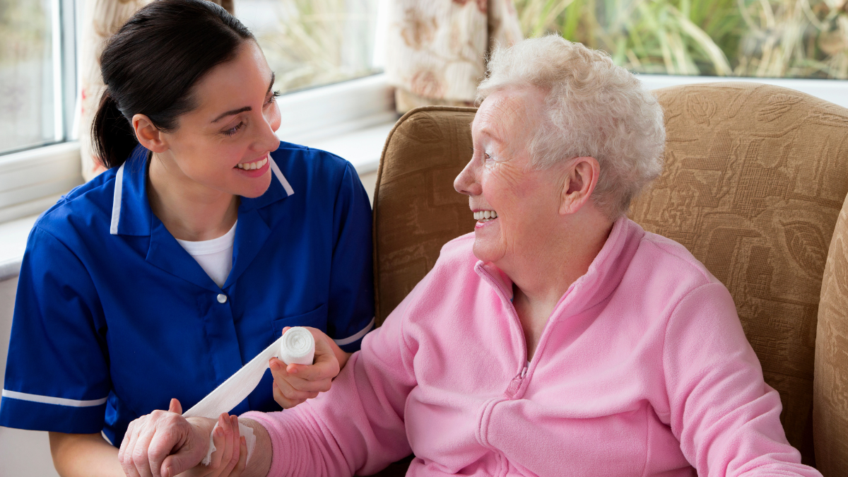 healthcare professional bandaging elderly patient's writs