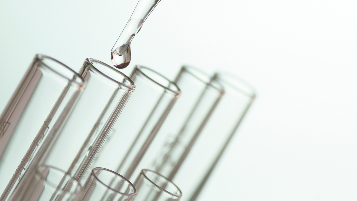 test tubes with liquid being pipetted in