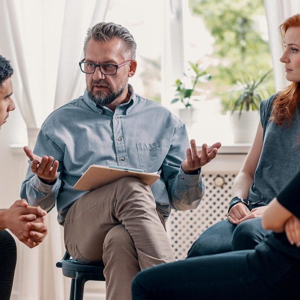 people sat around in a circle meeting