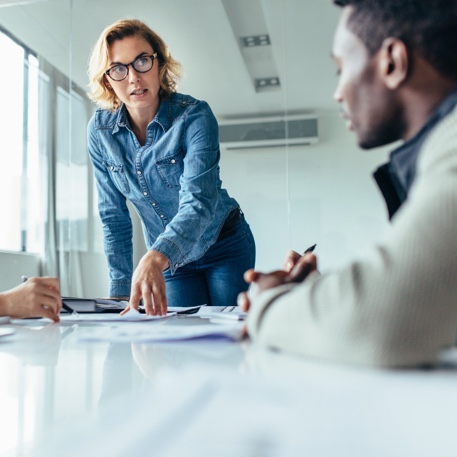 meeting with woman stood up delivering talk
