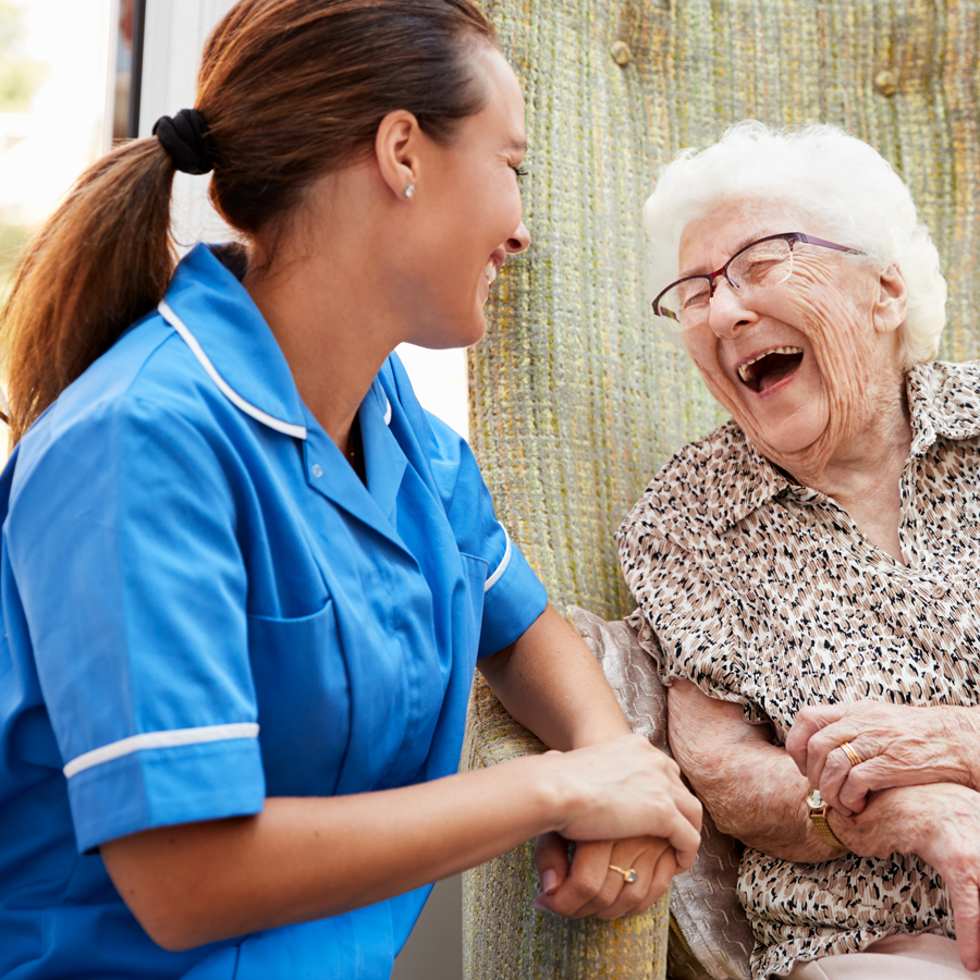 Care worker smiling with elderly lady