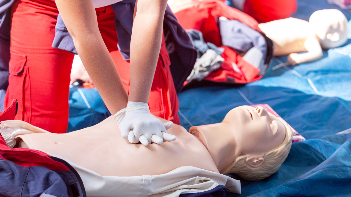 person giving CPR to dummy
