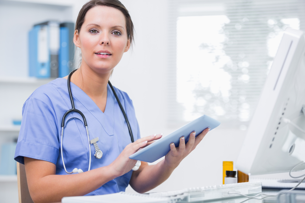 Portrait Of Young Female Surgeon Using Digital Tablet