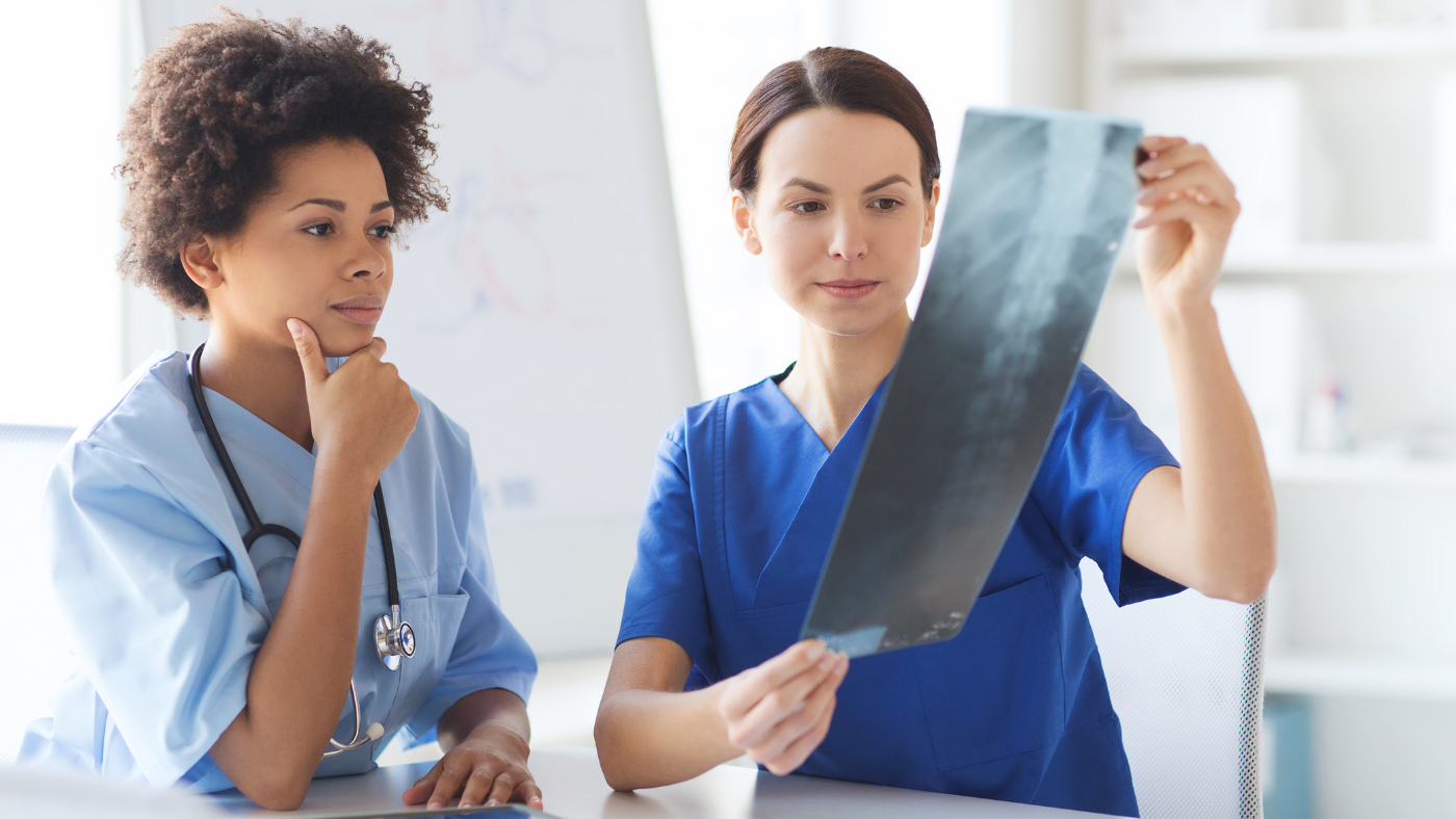 Two medical workers examining X-ray
