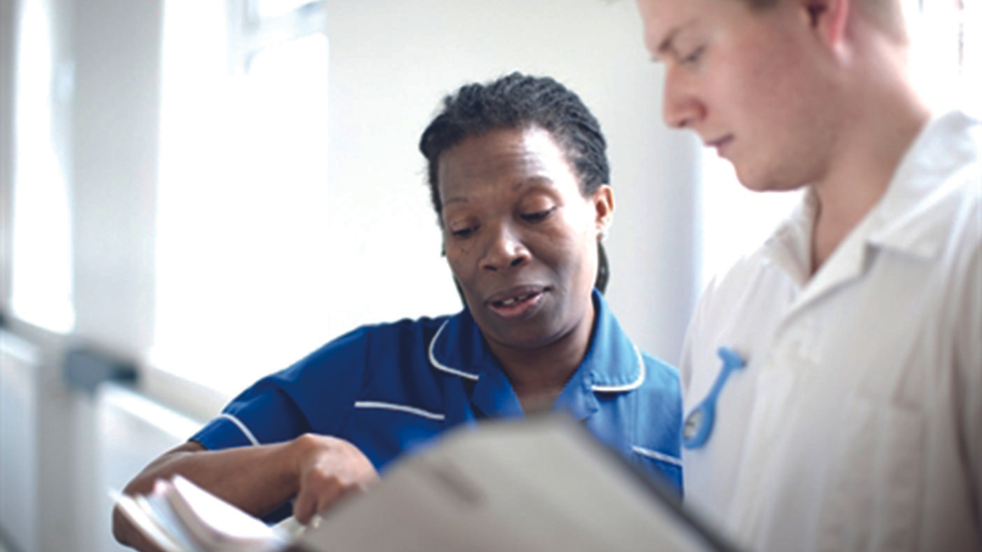 medical workers looking a folder/document