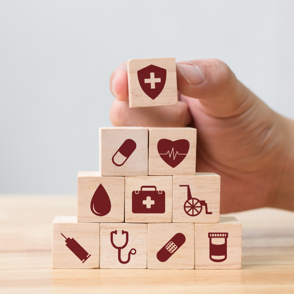 wooden blocks with medical icons being stacked up