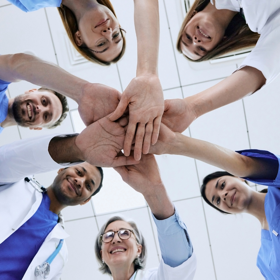 Healthcare team putting hands together in circle
