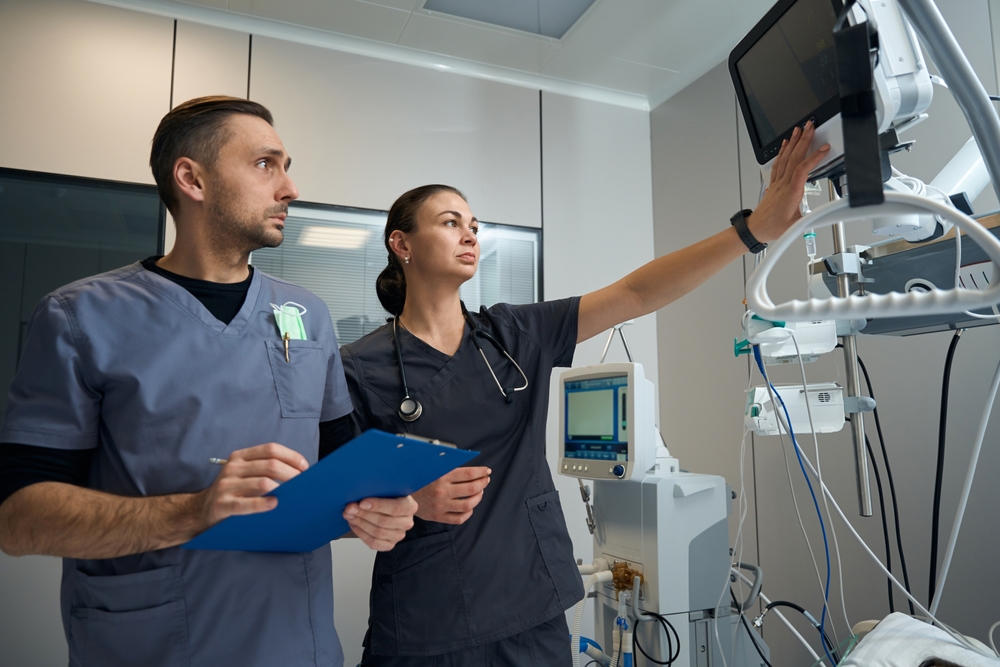 Medical workers looking on screen in the hospital