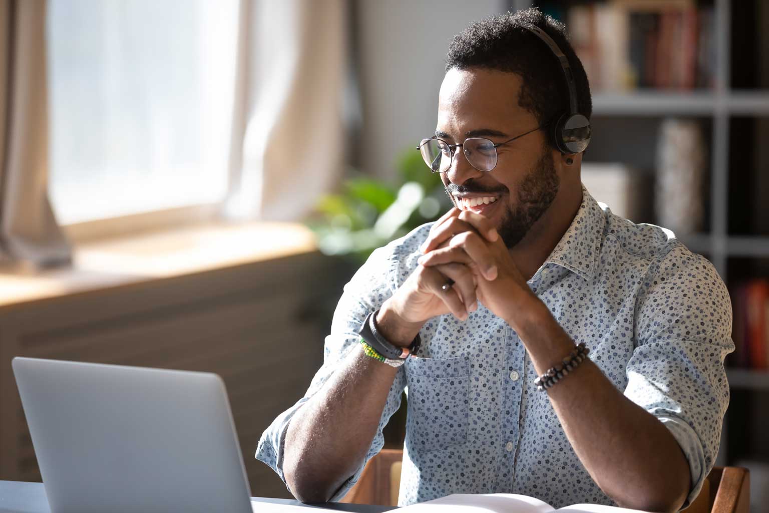 Photo of man sat at laptop computer