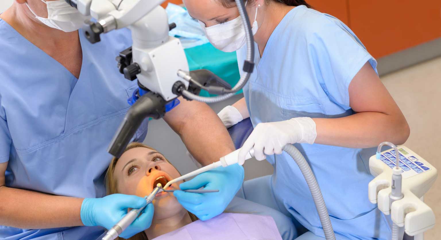 Dental Nurse assisting a Dentist with a young patient