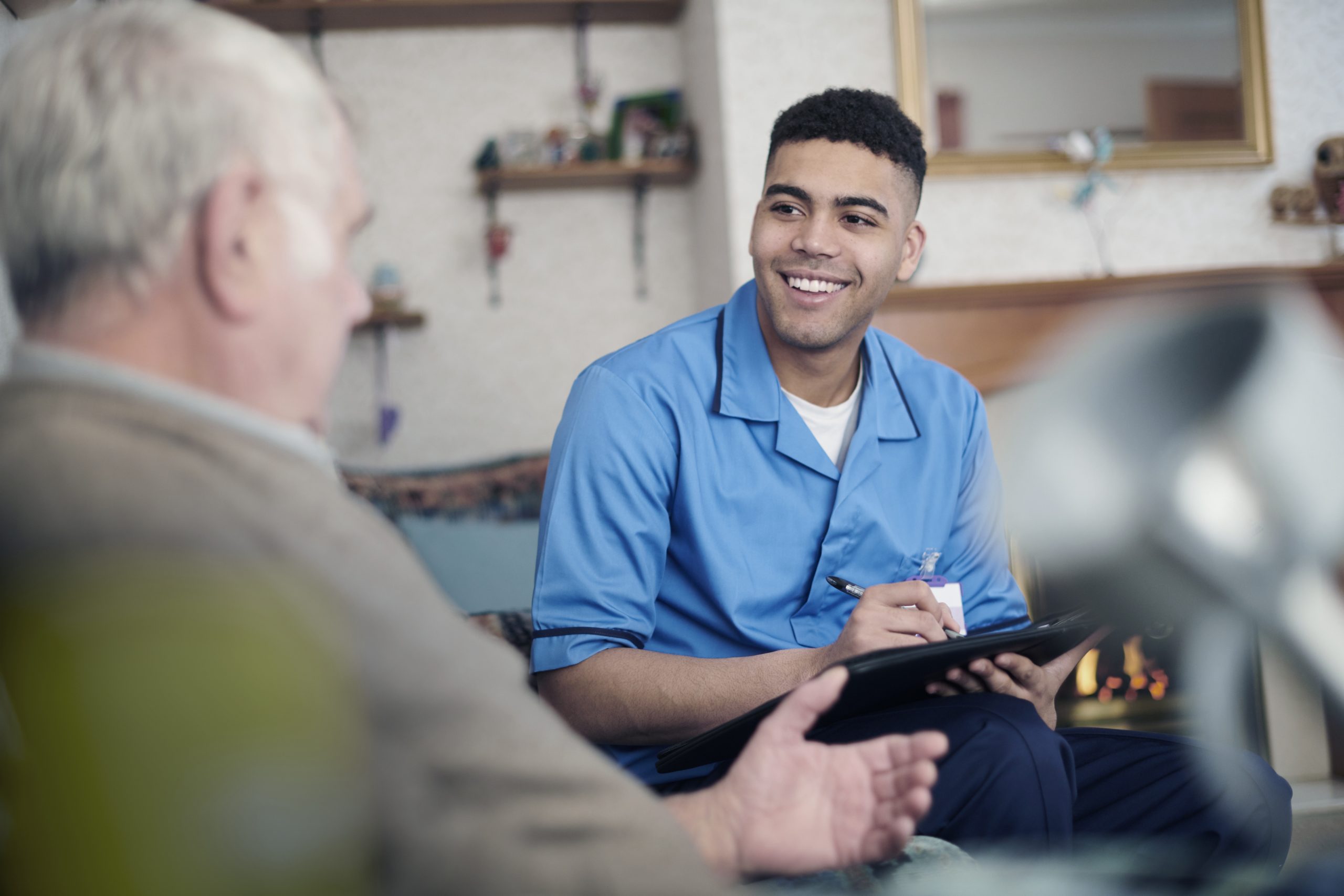 Nurse listening to patient with a smile on his face