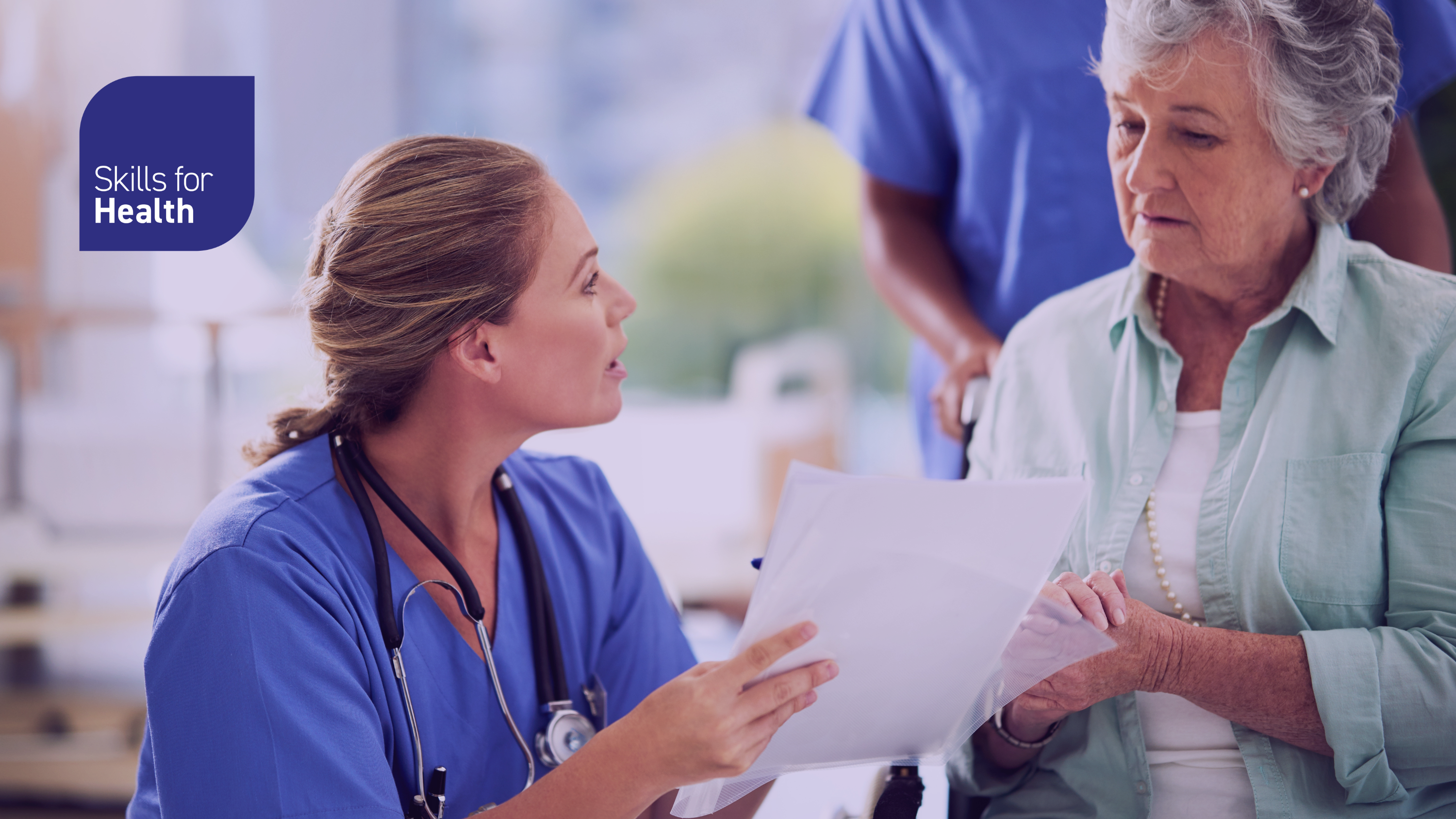 Medic writing notes, whilst talking to a patient
