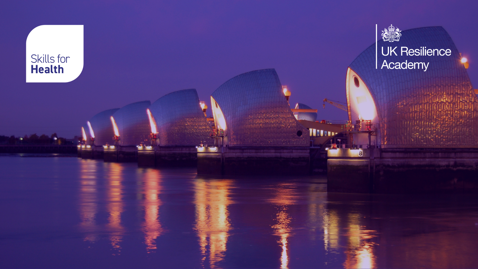 Image of buildings on waterfront with lights on, with Skills for health, and UK Resilience Academy logos