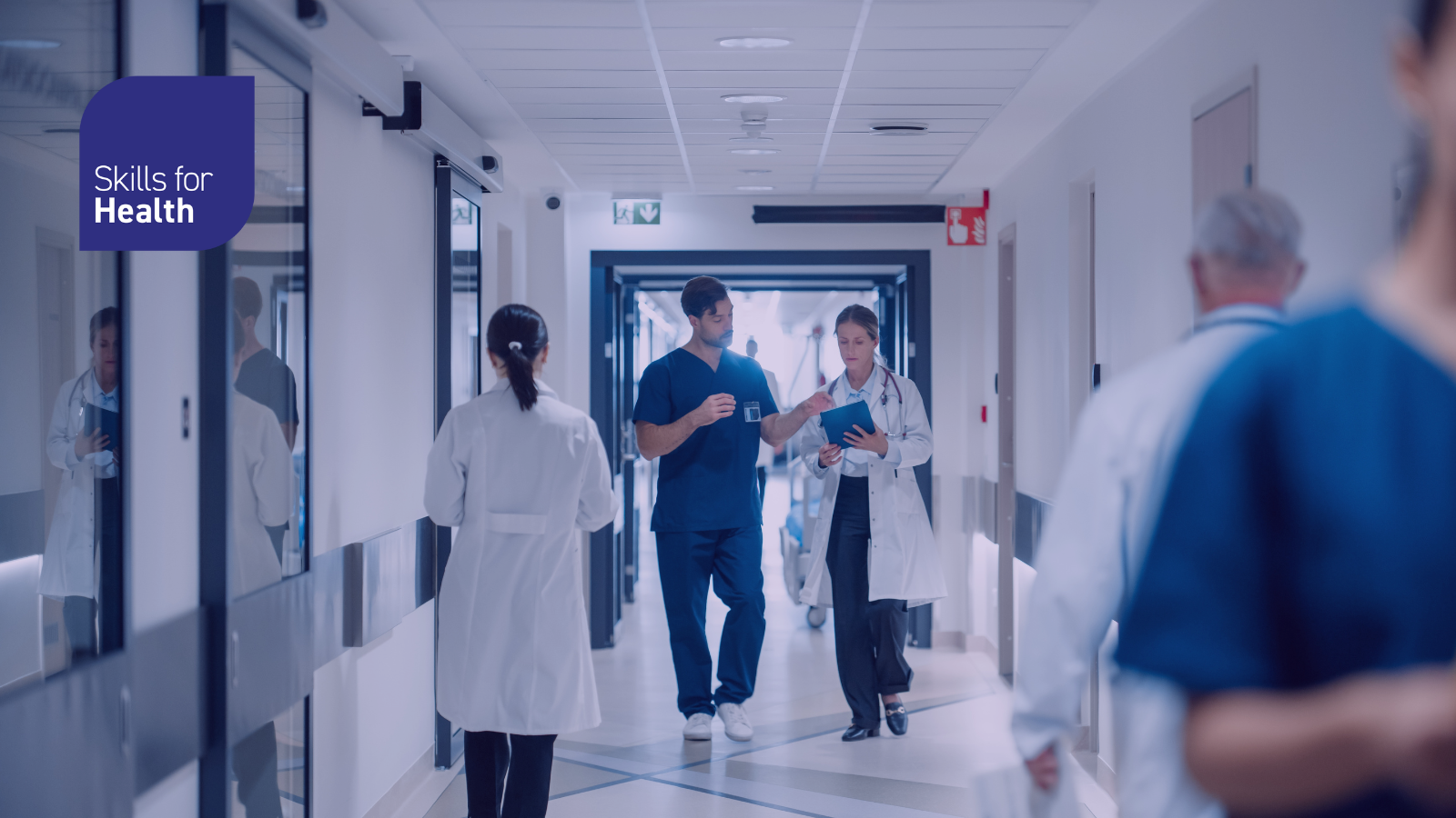 Image of medical staff working in a busy hospital corridor