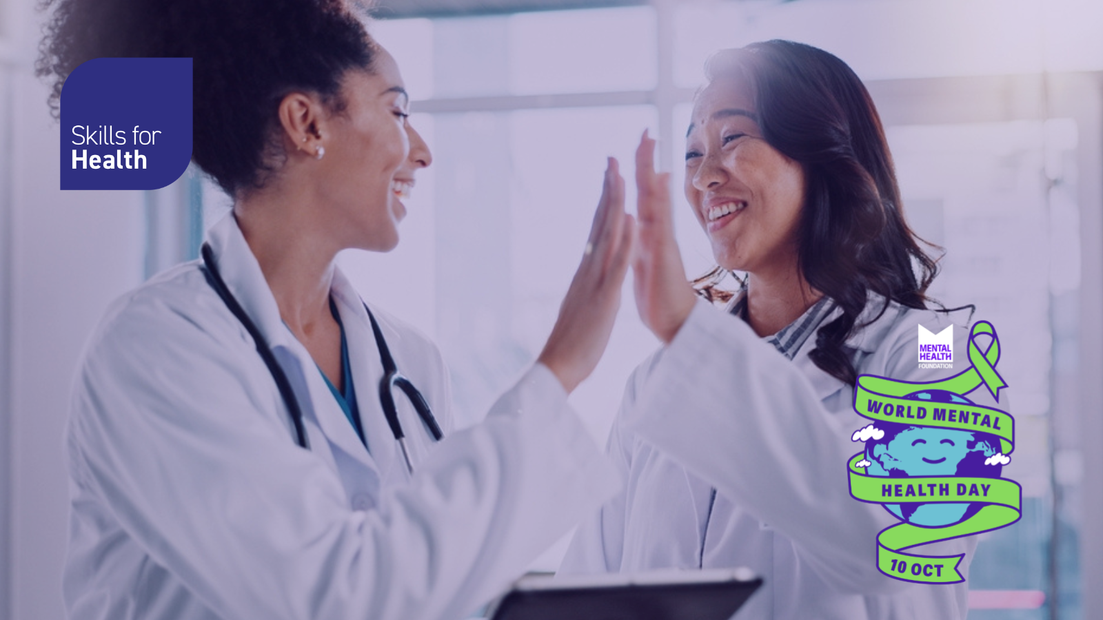 Two healthcare female workers high five and smile at each other - World Mental Health Day 10 Oct 2025 logo is displayed
