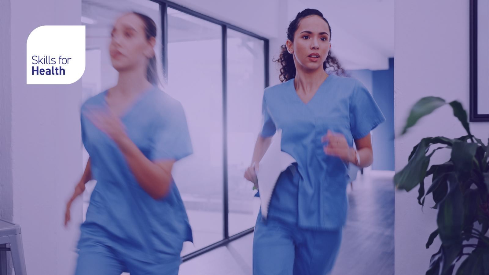 Two women, nurses or medical staff looking determined and running along a hospital corridor.