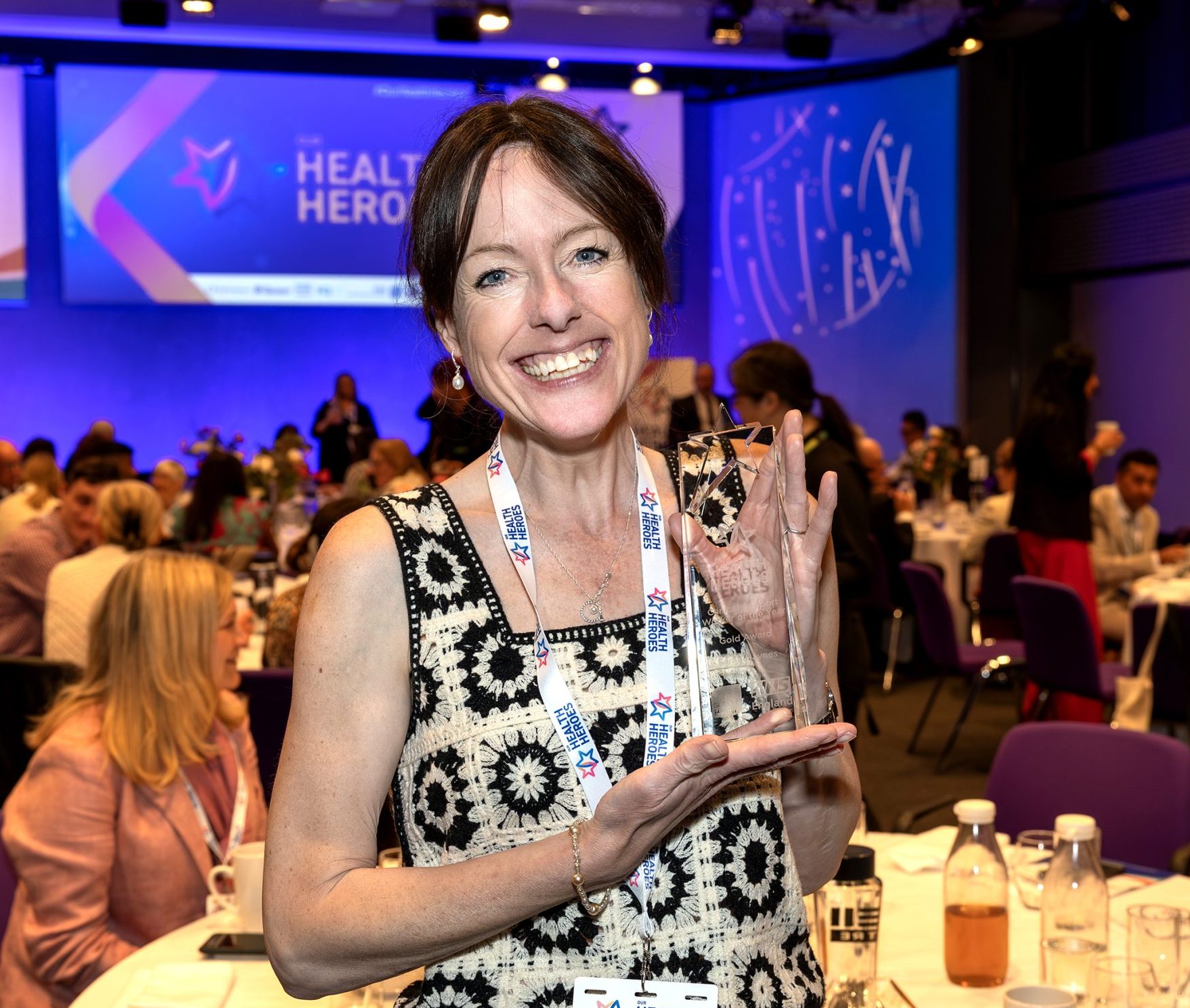 Smiling woman holding a winner's trophy