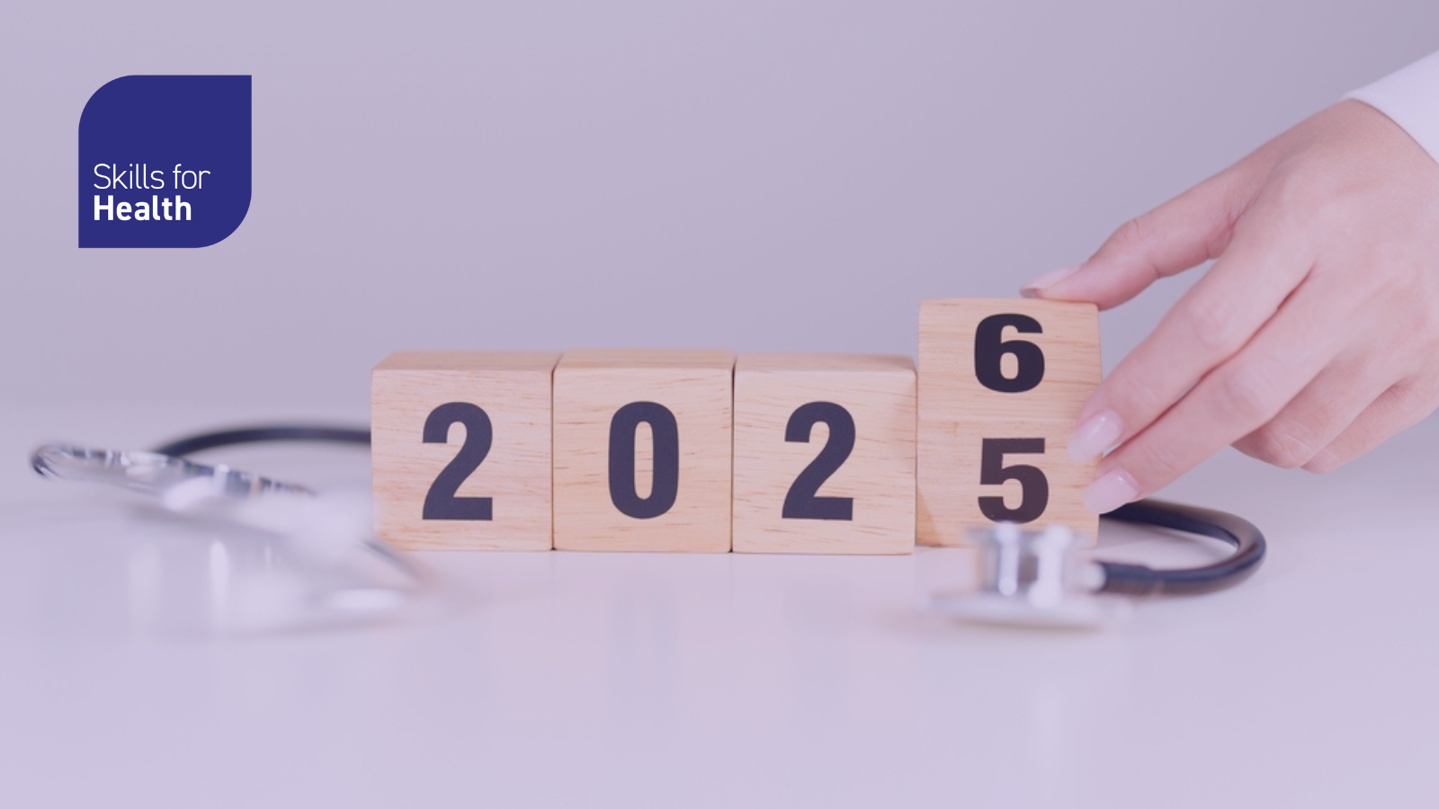 2025 end year to Happy New Year 2026 with Stethoscope of doctor and heart shape on table. health care, Insurance, Wellness and medical concepts