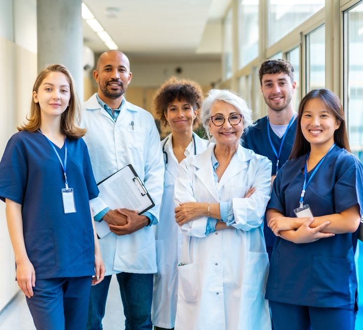 Doctors and nurses standing together in a hospital corridor, representing teamwork and professionalism in healthcare